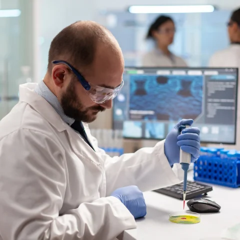 biochemistry-health-care-scientist-testing-blood-sample-using-micropipette