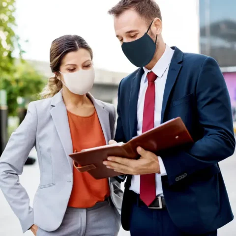 business-people-medical-masks-discussing-work-plan-coronavirus-pandemic