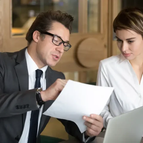 businessman-consulting-with-female-colleague-contract-conditions