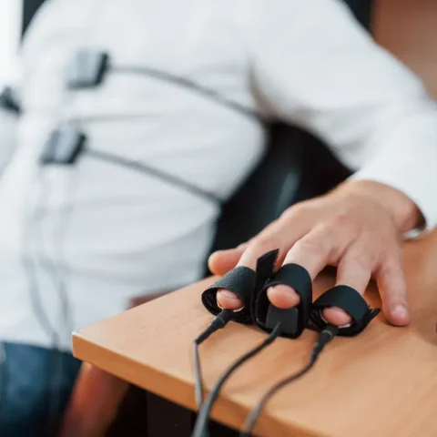 electrodes-fingers-suspicious-man-passes-lie-detector-office-asking-questions-polygraph-test