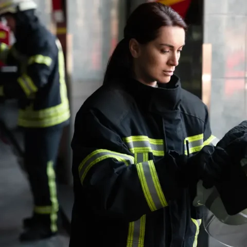 female-firefighter-putting-safety-helmet
