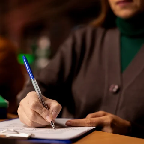 focused-woman-transcribing-class-notes-her-university-degree