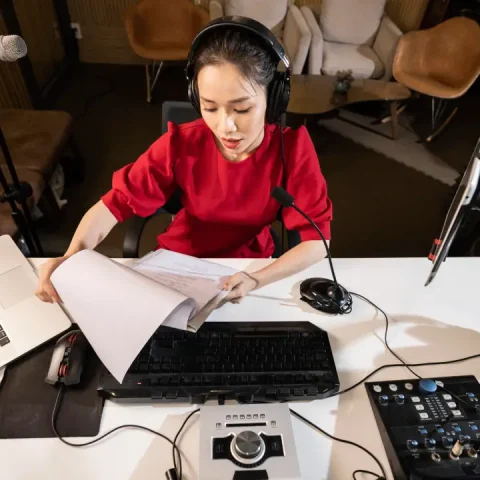high-angle-woman-working-radio-with-professional-equipment