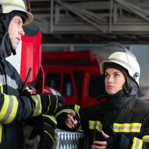 male-female-firefighters-working-together-suits-helmets