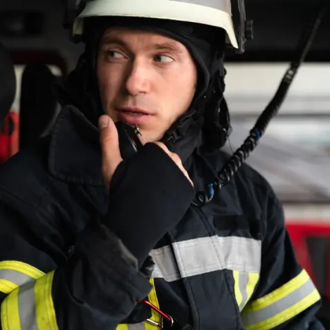 male-firefighter-fire-truck-using-radio-station