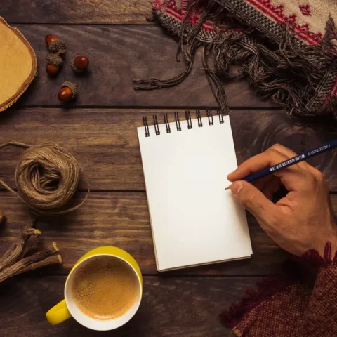 man-writing-elegant-autumn-workplace
