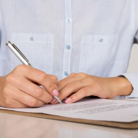 person-signing-contract-certificate