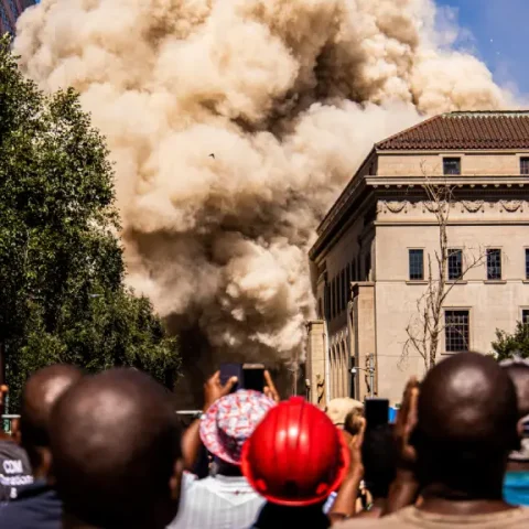 vertical-shot-crowd-people-watching-filming-smoke-from-explosion