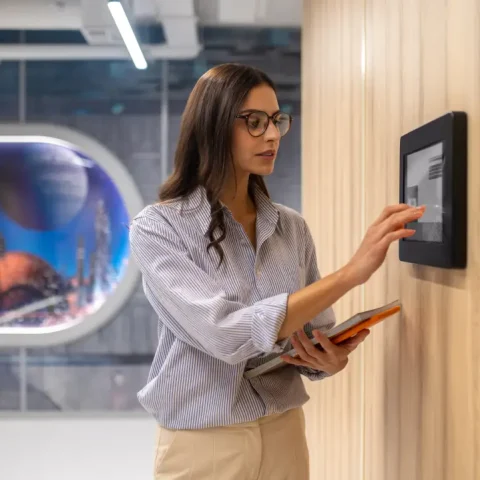 woman-touching-control-panel-wall-corridor