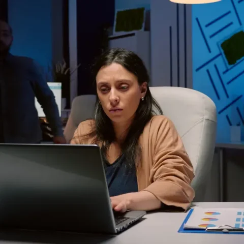 workaholic-tired-businesswoman-typing-financial-statistics-laptop