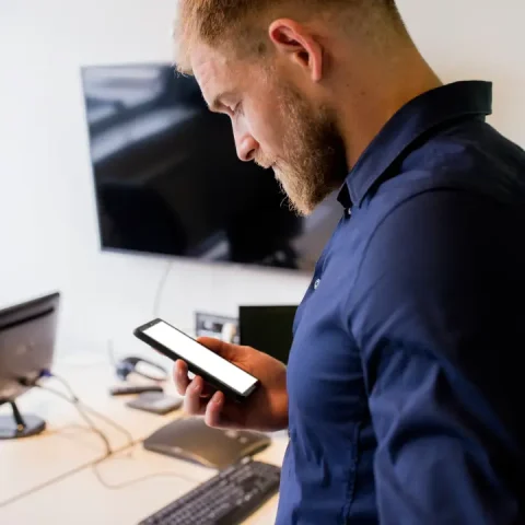 young-businessman-looking-blank-screen-mobile